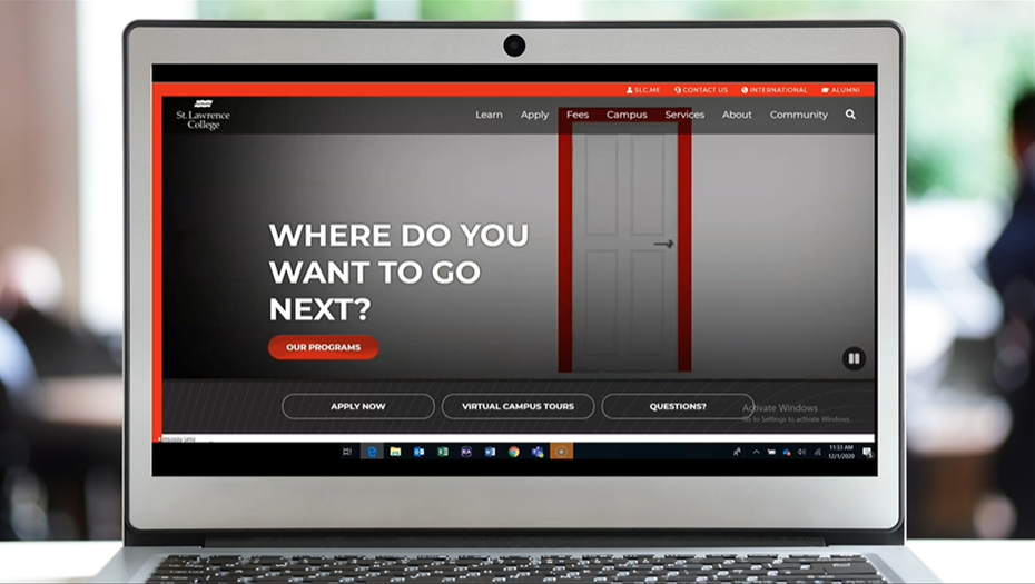 A laptop screen displays the new SLC website with the text Where do you want to go next? and a door, waiting to be opened